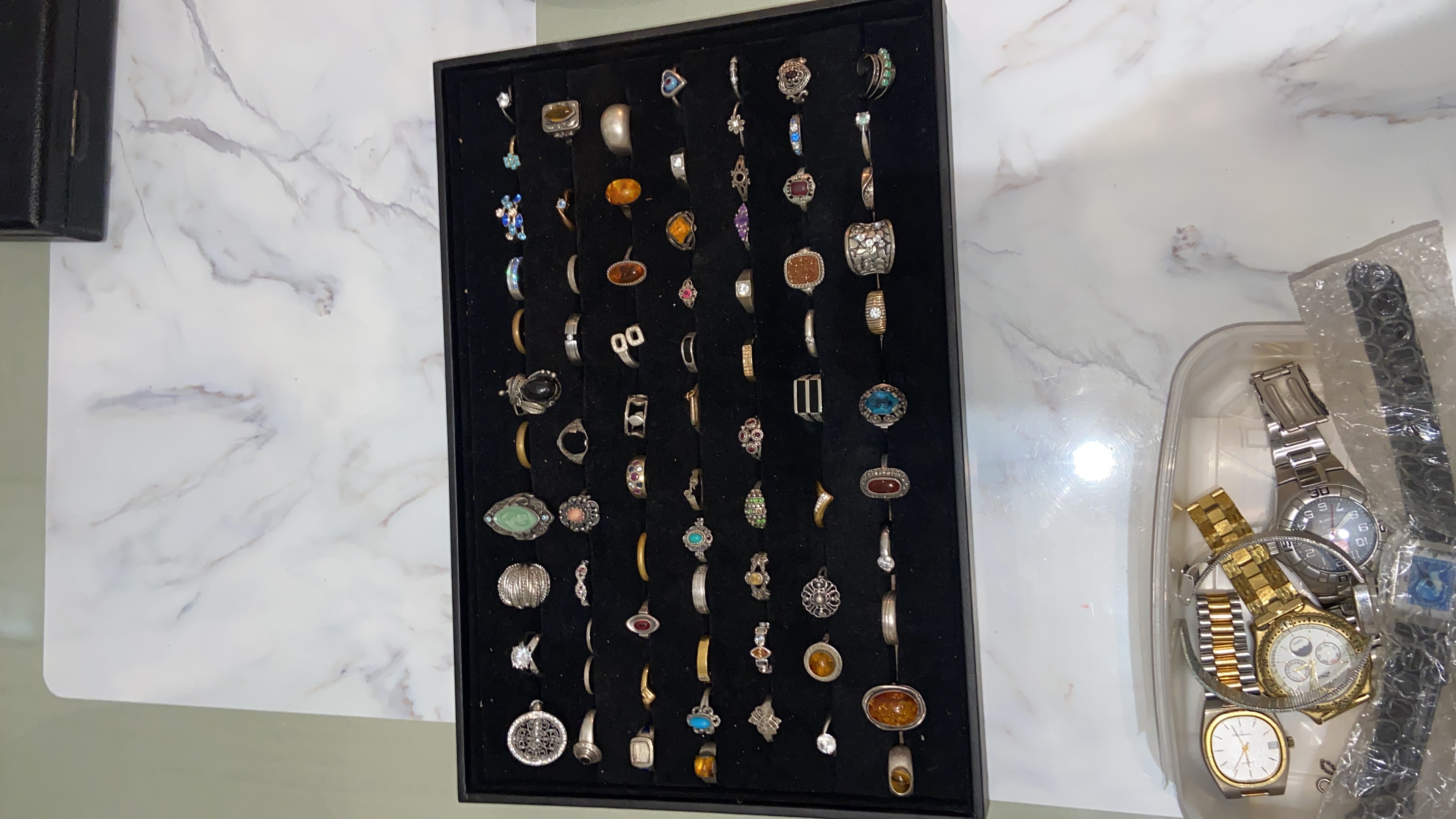 Großes Konvolut aus verschiedenen Ringen und Armbanduhren im Samt-Display